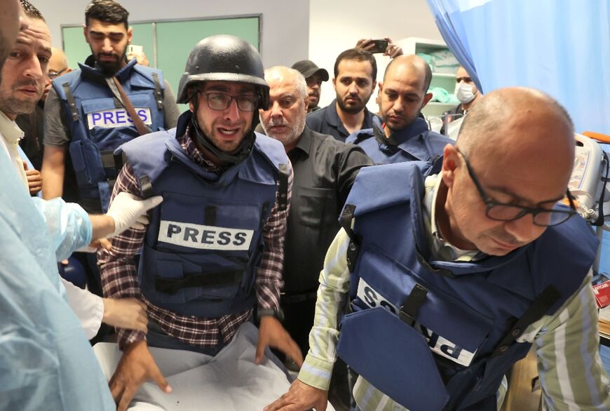 Journalists escort the body of veteran Al Jazeera reporter Shireen Abu Aqleh, who  was shot dead by Israeli troops as she covered a raid on Jenin refugee camp in the occupied West Bank