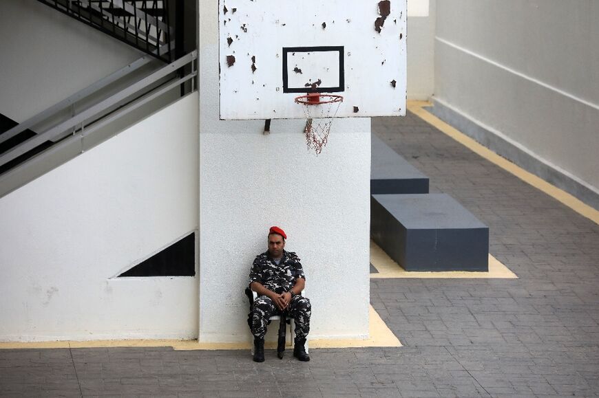 A member of the Lebanese internal security forces guards a polling station in the capital Beirut's southern suburbs, during the parliamentary election, on May 15, 2022