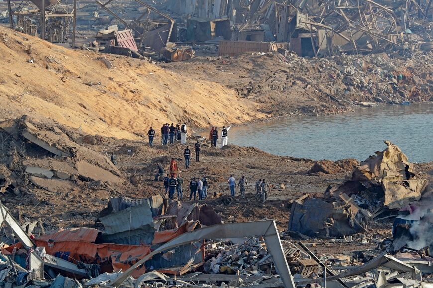 Police and forensic officers work at the scene of the massive explosion at the port of Lebanon's capital Beirut, on August 5, 2020