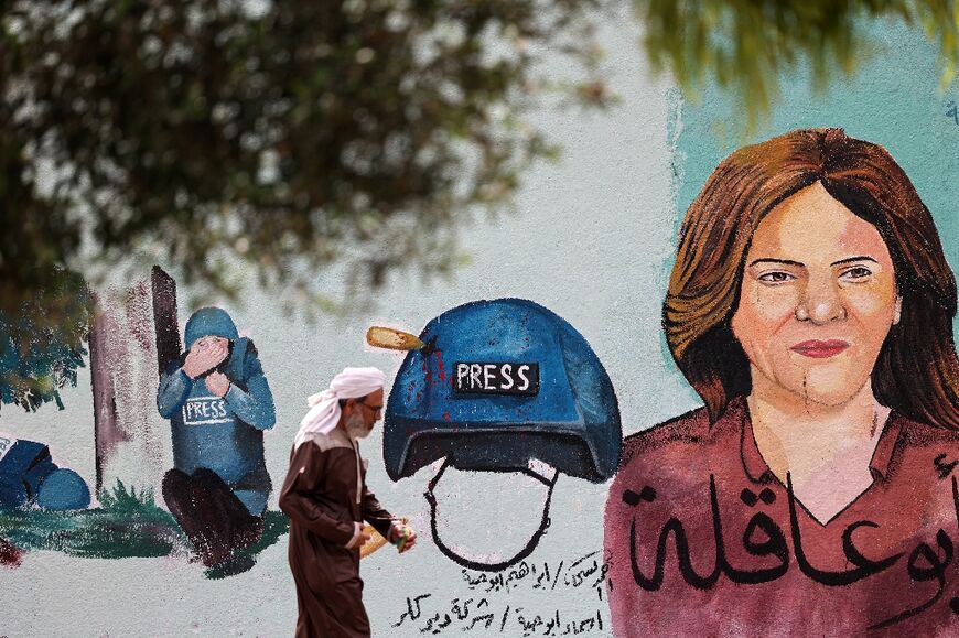 A Palestinian man walks past a mural painted in honour of veteran Al Jazeera journalist Shireen Abu Akleh in Gaza City