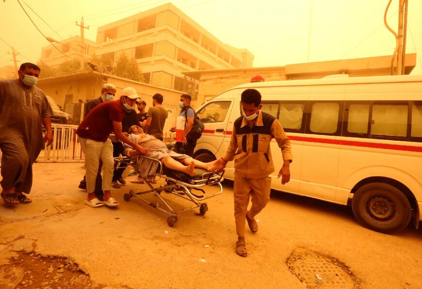 A patient suffering from breathing problems arrive at Baghdad's Sheikh Zayed Hospital