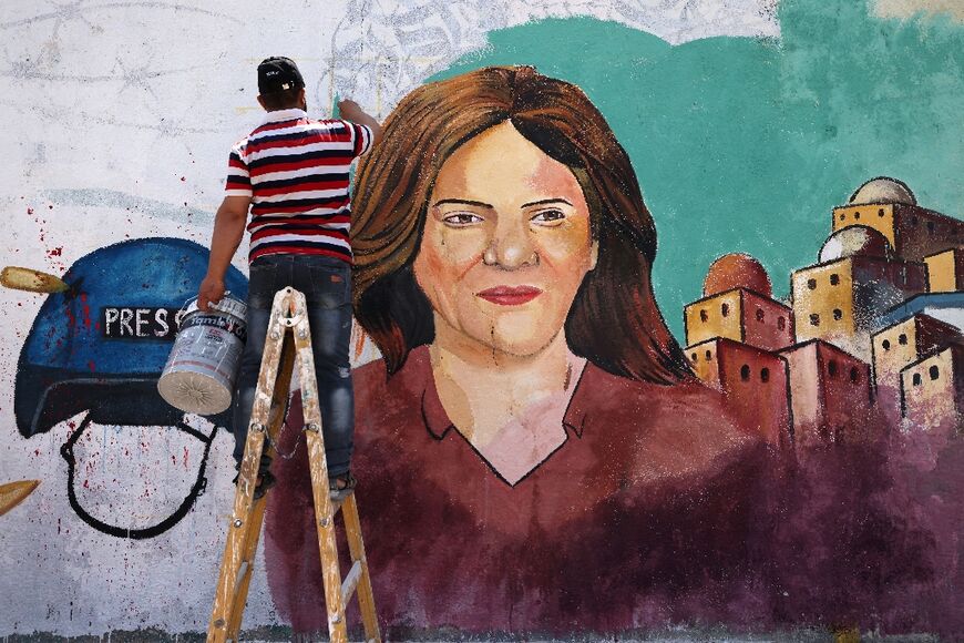 Palestinian artists paint a mural in honour of slain veteran Al Jazeera journalist Shireen Abu Akleh in Gaza City on May 12