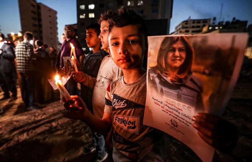 Children in Gaza take part in a candlelight vigil to condemn the killing of Shireen Abu Akleh