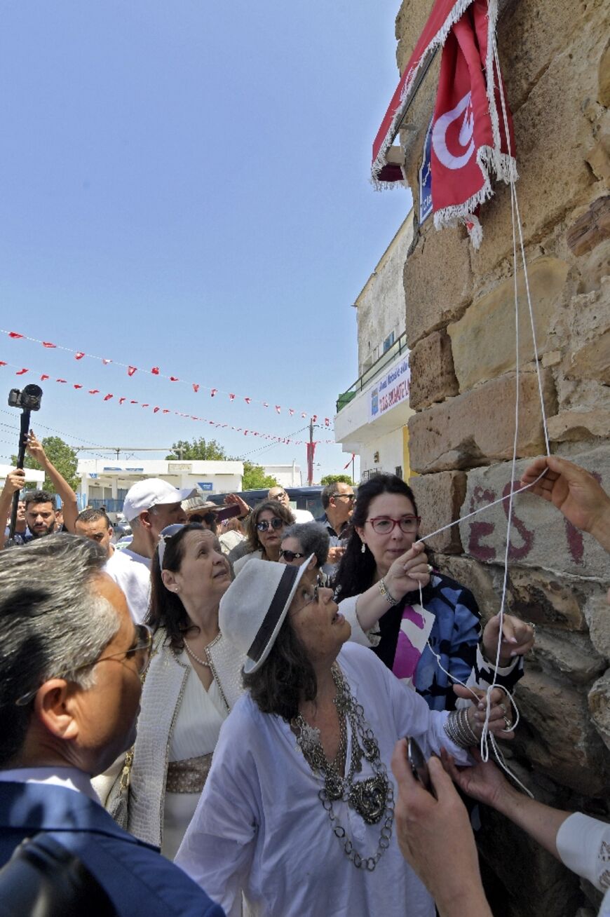 Claudia Cardinale watches the unveiling of a sign marking "Claudia Cardinale" street