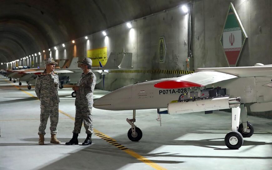 A handout picture provided by the Iranian army shows Iranian Army Major General Abdolrahim Mousavi and Armed Forces Chief of Staff Major General Mohammad Bagheri visiting the underground drone base