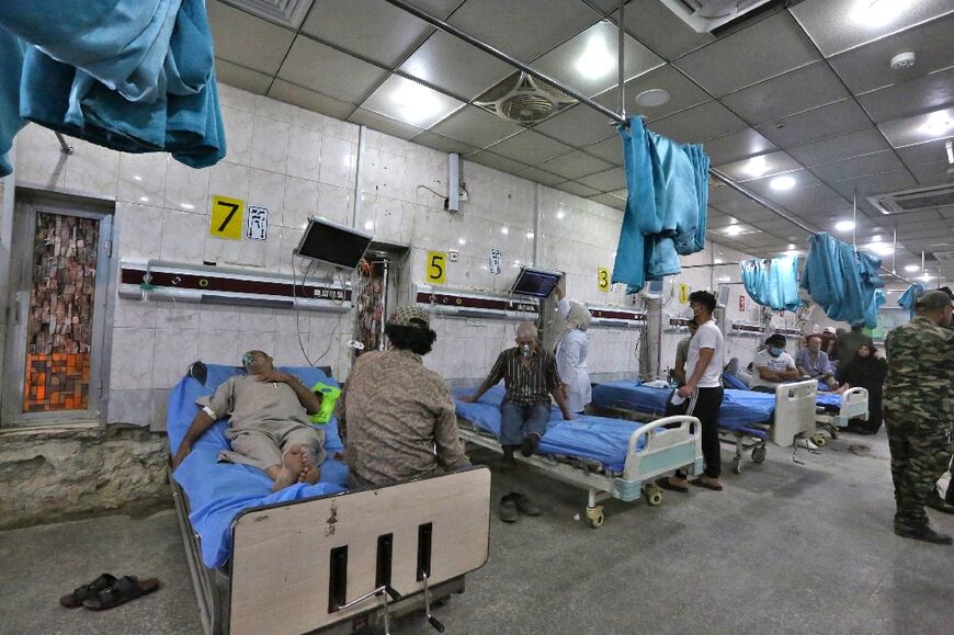 Patients suffering from breathing problems exacerbated by a heavy dust storm receive care at Sheikh Zayed Hospital in Iraq's capital Baghdad on May 16, 2022