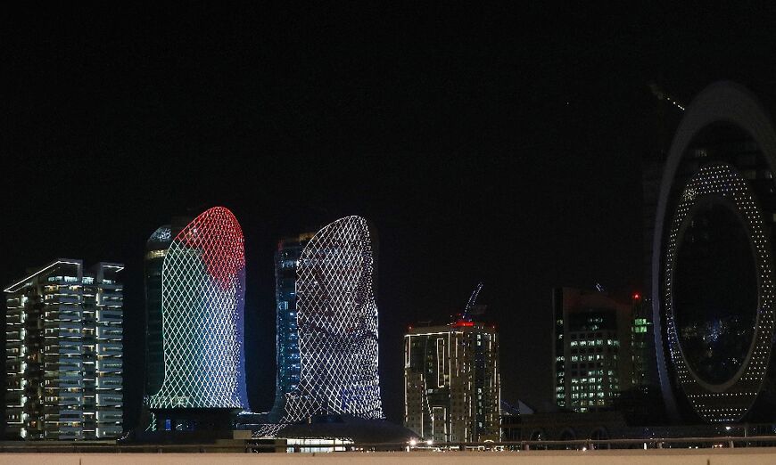 A portrait of Abu Akleh and the Palestinian flag are displayed on a building in the Qatari capital Doha