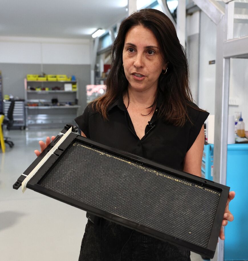 Director of operations at Beewise Netaly Harari shows an automated beehive, part of the high-tech project located in Kibbutz Beit Haemek