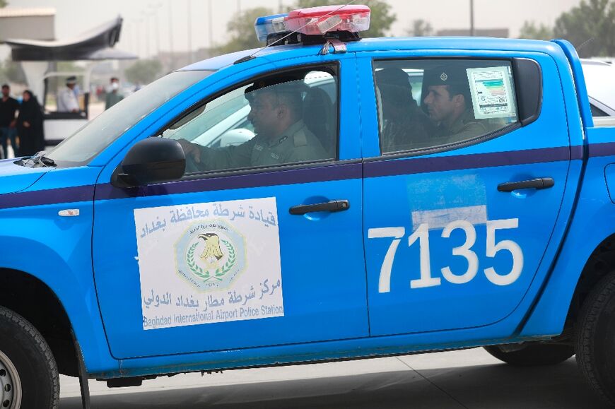 Police drive the two men, James Fitton and Volker Waldmann, to the Karkh Appeal Court in Baghdad on Monday