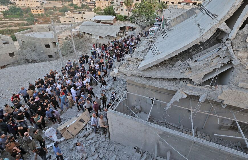 Residents of the West Bank village of Yabad inspect the family home of alleged Palestinian shooter Diaa Armashah, after its demolition by the Israeli army in a raid that left one Palestinian dead