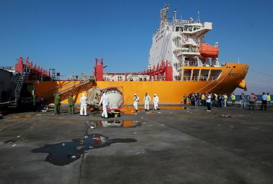 Forensics experts inspect the site of a toxic gas explosion at Jordan's Red Sea port of Aqaba