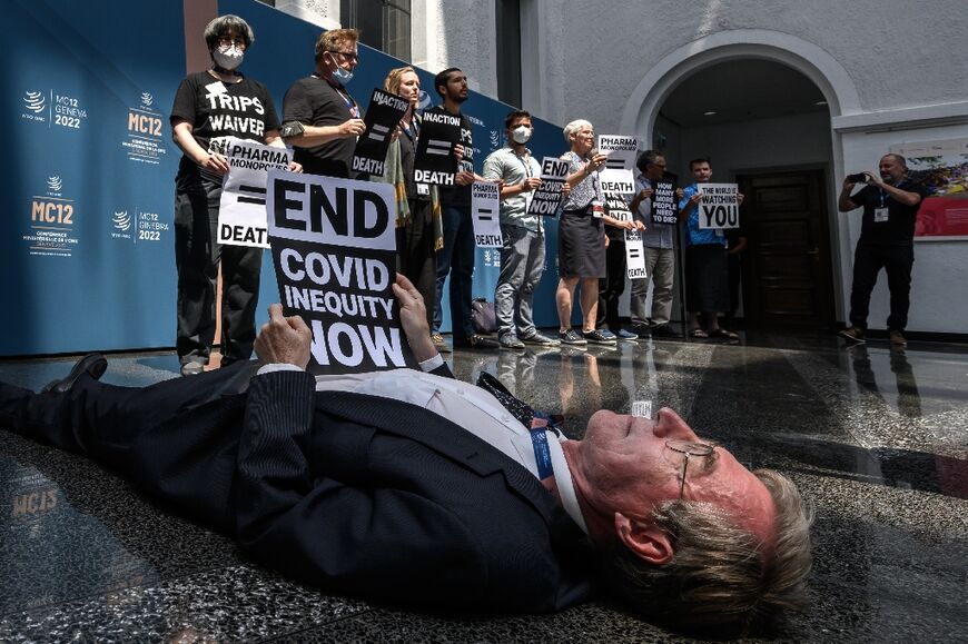 Activists staged a 'die-in' protest in the WTO's atrium, accusing some countries of scuppering a meaningful Covid intellectual property waiver