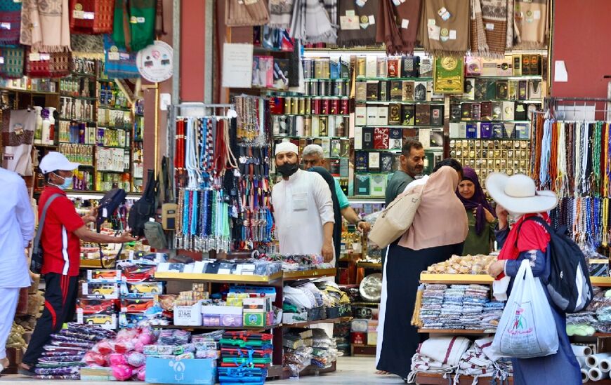 Muslim pilgrims shop at a market in Mecca -- the hajj is welcoming its first international visitors since 2019