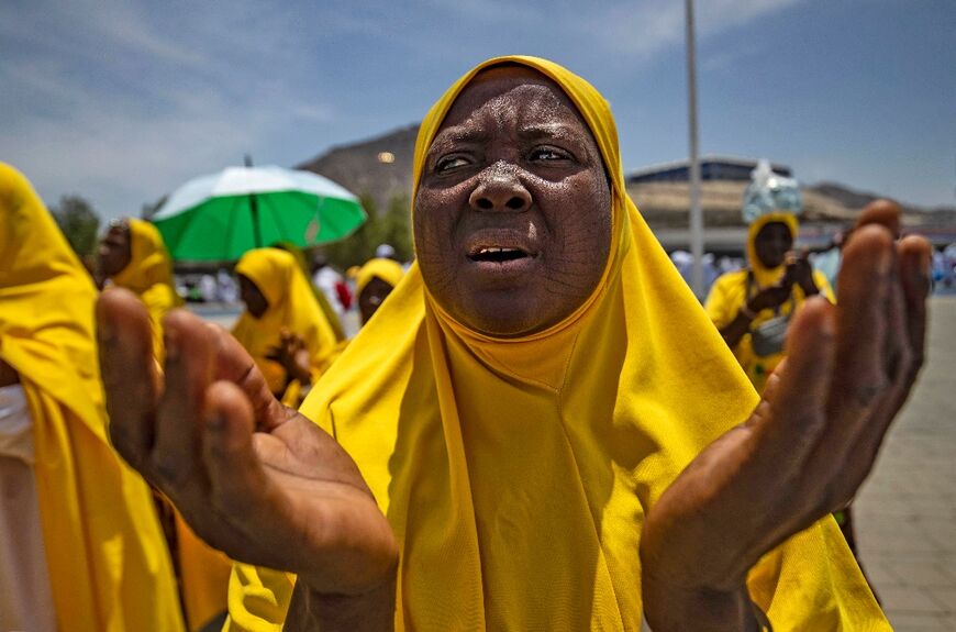 A Muslim woman prays around Mount Arafat