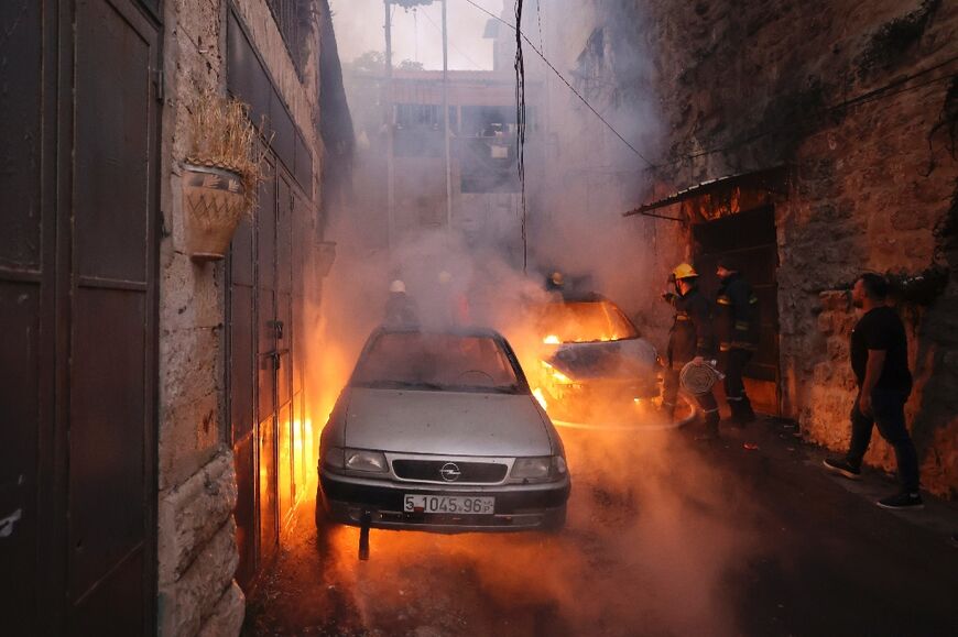 Palestinian rescue teams rush to the scene of clashes between Israeli troops and Palestinian gunmen in the Old City of Nablus in the northern occupied West Bank early on July 24, 2022