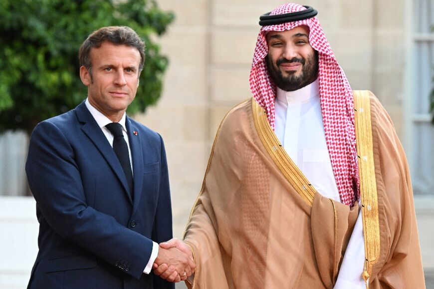 Macron warmly greeted the kingdom's de-facto ruler ahead of a dinner, defying objections from activists