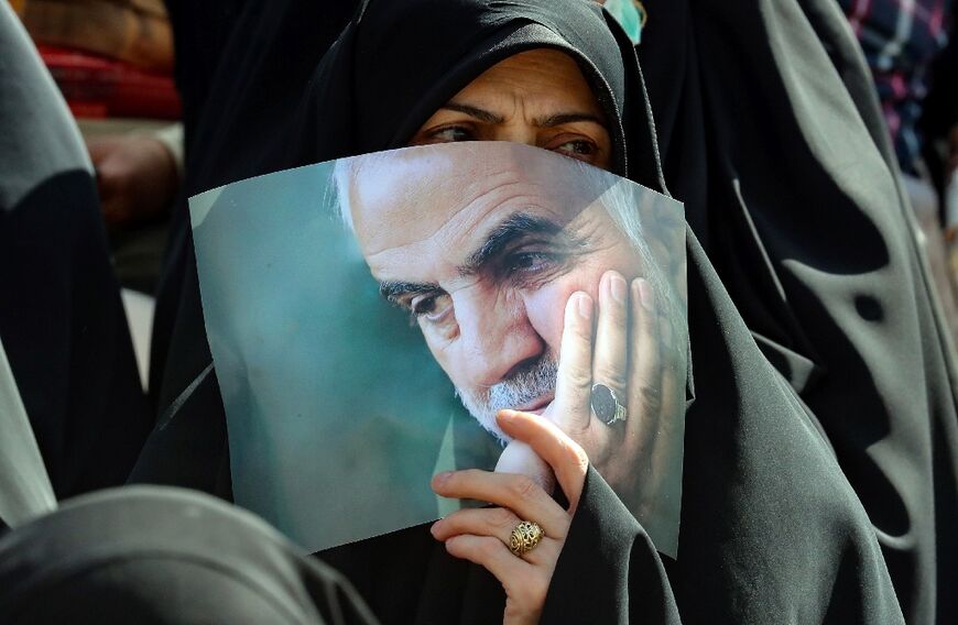 An Iranian carries a portrait of tje slain head of Iran's Islamic Revolutionary Guard Corps' "Quds Force", Qasem Soleimani, during a gathering in Tehran on May 26, 2022