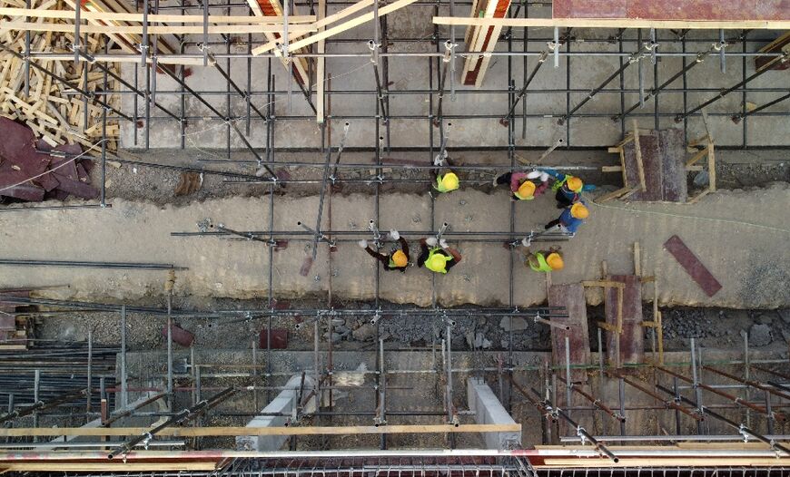 Labourers work on the construction site for a school, part of the Iraq-China "oil for construction" deal, in the Sumer neighbourhood of Nasiriyah city, in Iraq's southern Dhi Qar province