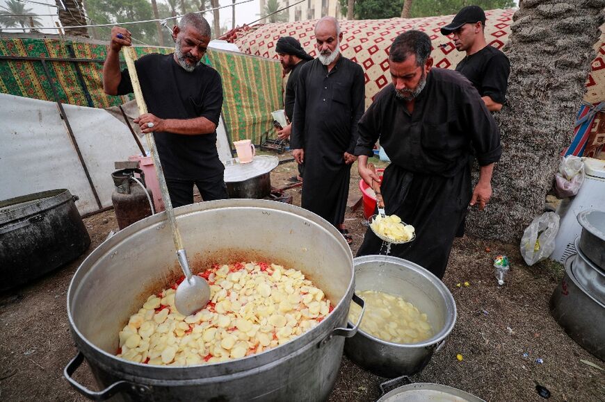 Volunteers prepare food for Sadr supporters at a sit-in protest outside the Iraqi parliament building