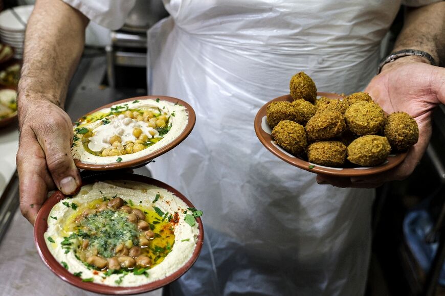 Plates of hummus, fava beans and falafel are served at a restaurant in the Old City of Jerusalem 