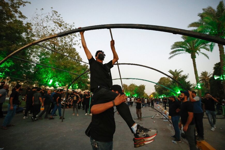 Supporters of Iraq's Coordination Framework set up tents after announcing a sit-in outside the capital Baghdad's Green Zone, on August 12, 2022