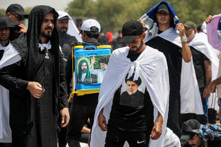 Tens of thousands turned out, bearing pictures of Sadr, despite baking 42 degrees Celsius temperatures