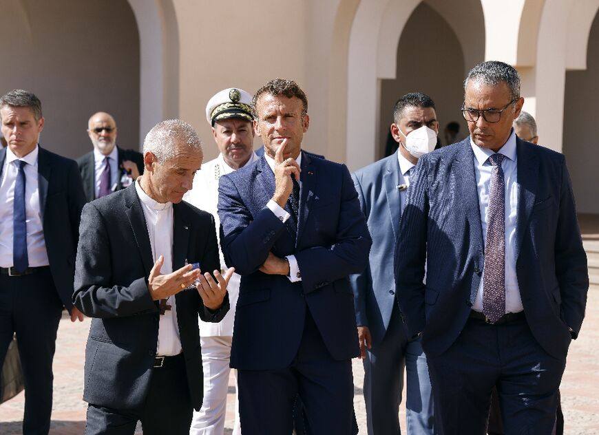 Macron met Algiers' archbishop Mgr Jean-Paul Vesco and French-Algerian writer Kamel Daoud during a visit to the Fort of Santa Cruz in Oran