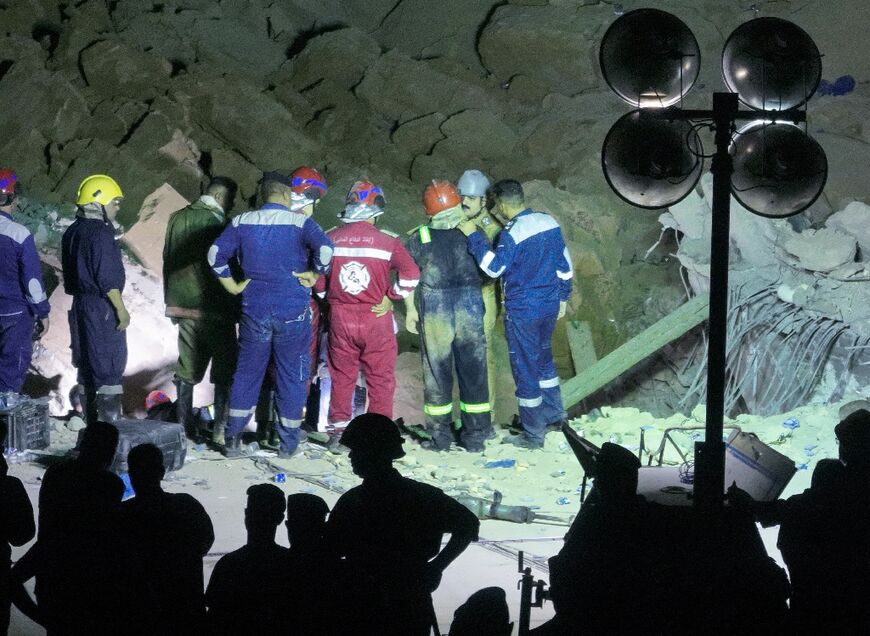 Iraqi emergency services search the rubble for survivors after a landslide hit the Qattarat al-Imam Ali shrine on the outskirts of the holy city of Karbala