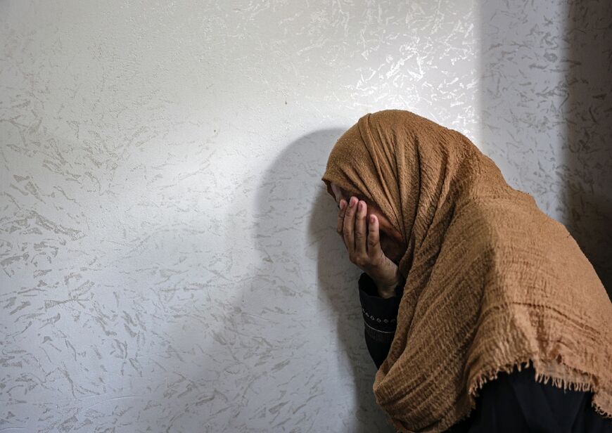 A relative in Khan Younis mourns on August 12, 2022 during the funeral of Palestinian Anas Anshasi, 22, after he succumbed to injuries sustained during Israeli air strikes on Gaza