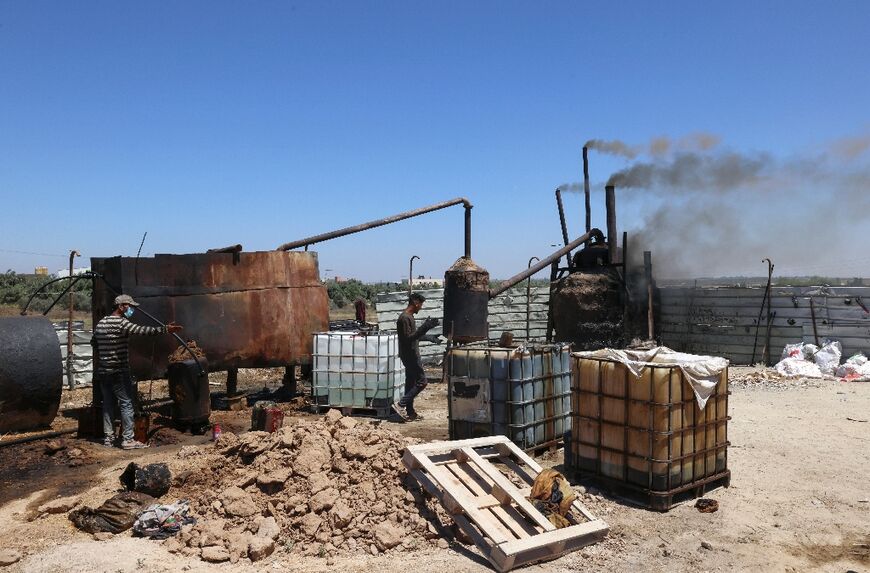 The process starts with the burning of wood in a furnace below a large mud-covered tank