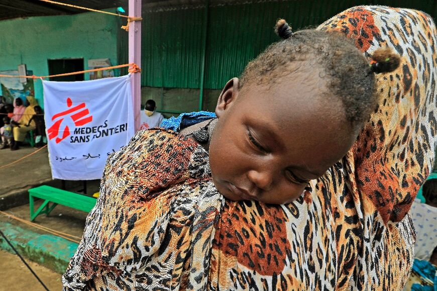 A family who fled clashes in Sudan's Blue Nile state last month wait at a clinic set up by health authorities in collaboration with Medecins Sans Frontieres