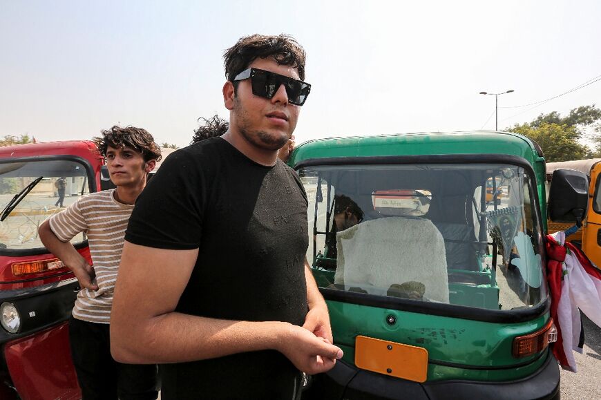 Rassul Achour, 20, has used his three-wheeled motorcycle taxi to shuttle protesters in the blistering summer heat