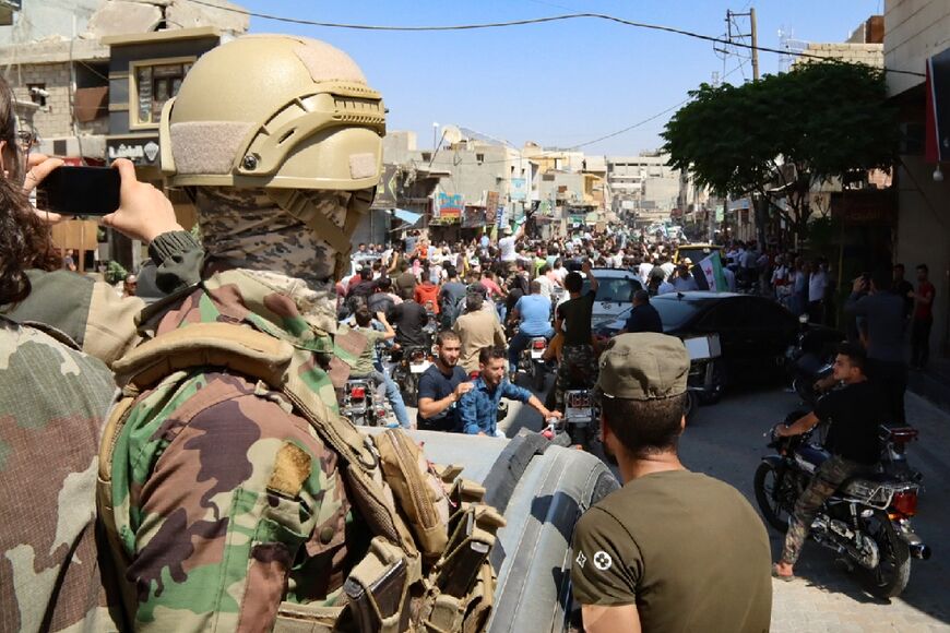 Turkey-backed Syrian fighters take part in a protest against comments from the Turkish foreign minister in the border town of Azaz in the rebel-held north of the Aleppo province