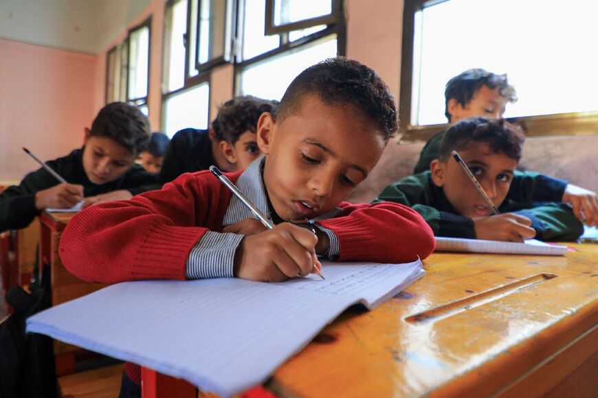 Yemeni boys get back to work at a school in the Huthi-controlled capital Sanaa, on August 2