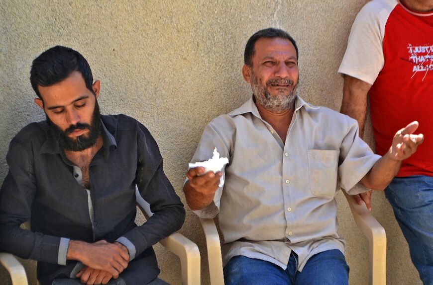 In the northern Lebanese city of Tripoli, relatives mourn a victim lost at sea when a boat carrying migrants from Lebanon sank off the Syrian coast