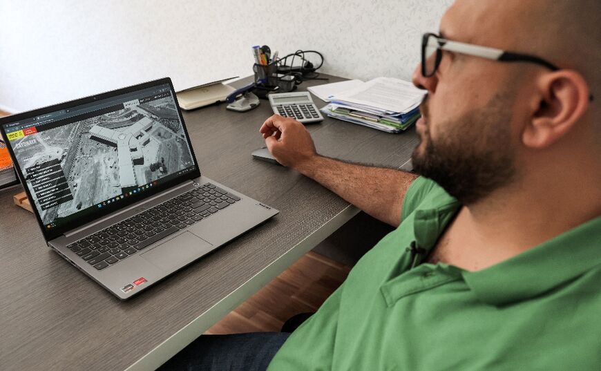 Diab Serriya, of the Association of Detainees and the Missing in Sednaya Prison, views a computer screen showing an image of the prison 