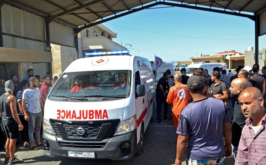 Ambulances wait on the Lebanese side of border with Syria for the return of bodies of victims of a migrant shipwreck disaster