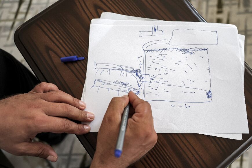 Moatassem Abdel Sater draws a rudimentary sketch of the prison plan 