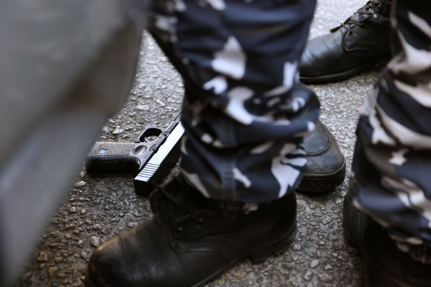 What appears to be a toy pistol is seen on the ground outside the bank