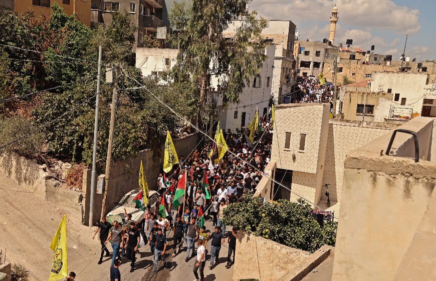 Protesters march in Kafr Dan after two Palestinians were killed in the overnight clash that also claimed the life of an Israeli soldier