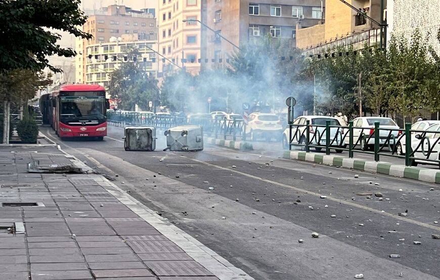 Smoke is seen rising from a burning bin during a protest in a photo obtained by AFP outside Iran