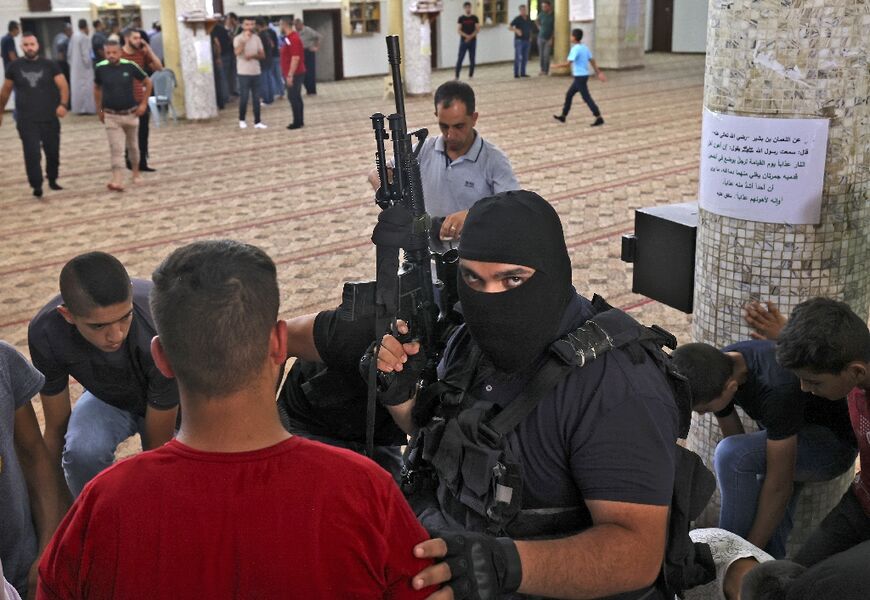 An armed militant joins mourners at the funeral of Mohammed Musa Mohammed Sabaaneh, 29, killed during the Israeli army incursion into the West Bank town of Jenin