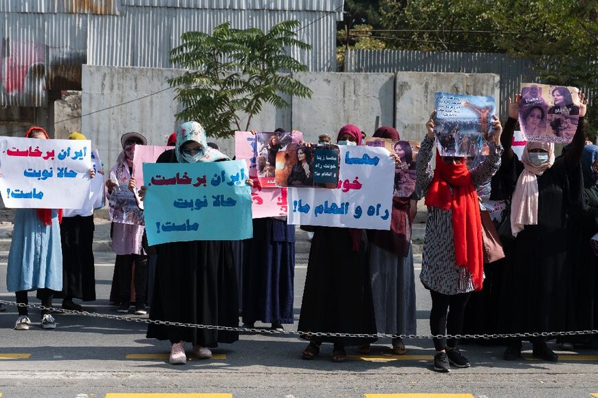 Afghan women protested in front of the Iranian embassy in Kabul on September 29, 2022 before Taliban forces fired shots into the air 