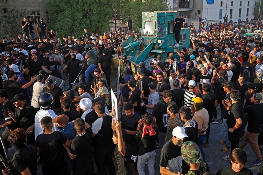 Iraqi supporters of Shiite Muslim cleric Moqtada Sadr clash with security forces in Tahrir Square