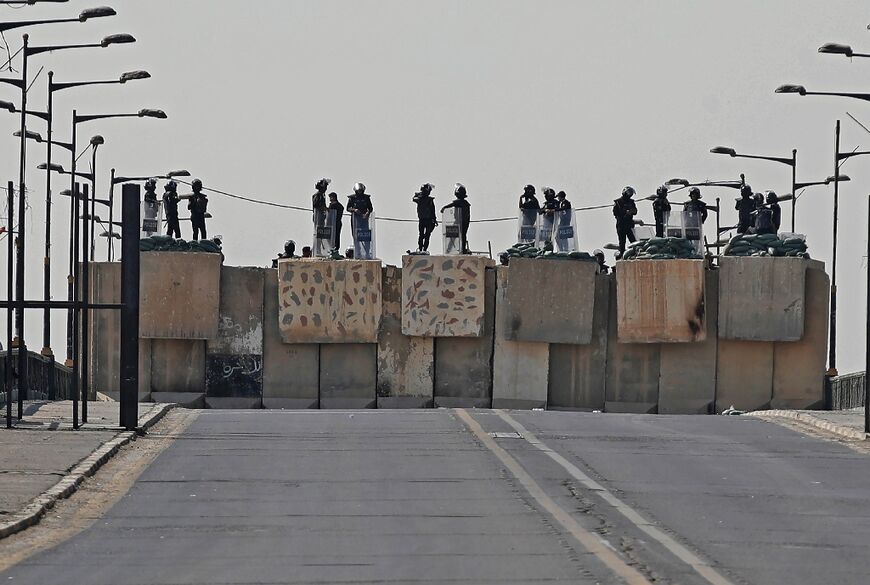 Iraqi security forces block a road leading to the Green Zone in Baghdad, as lawmakers gather for their fourth attempt this year to elect a new state president 