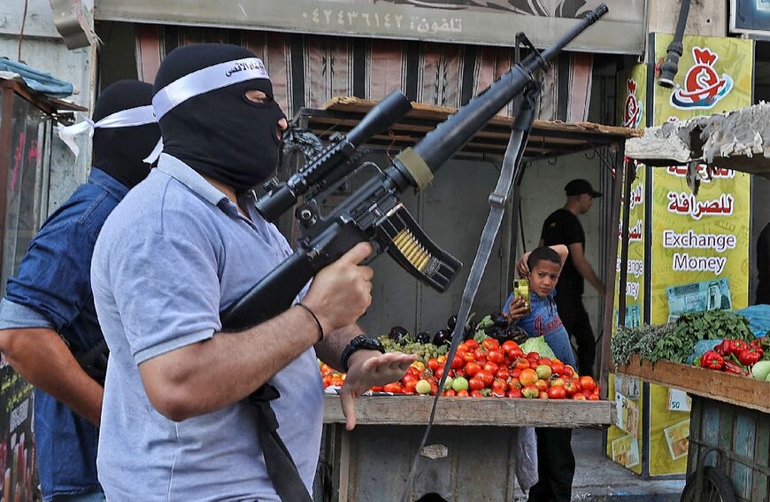 Palestinian gunmen take part in the funeral of Abdullah al-Ahmadin Jenin refugee camp in the Israeli- occupied West Bank, on October 14, 2022.