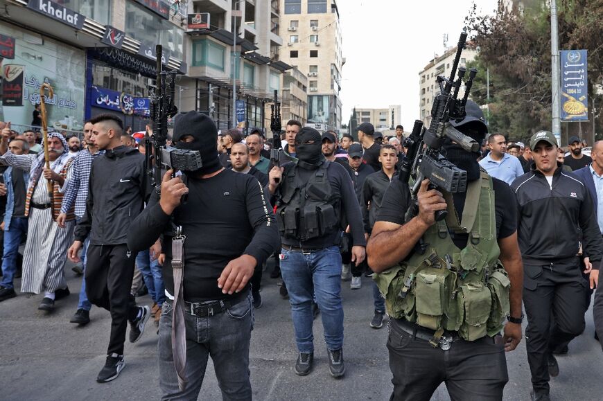 Palestinian militants attend the funeral of those killed in an overnight Israeli raid in the occupied West Bank city of Nablus on Tuesday