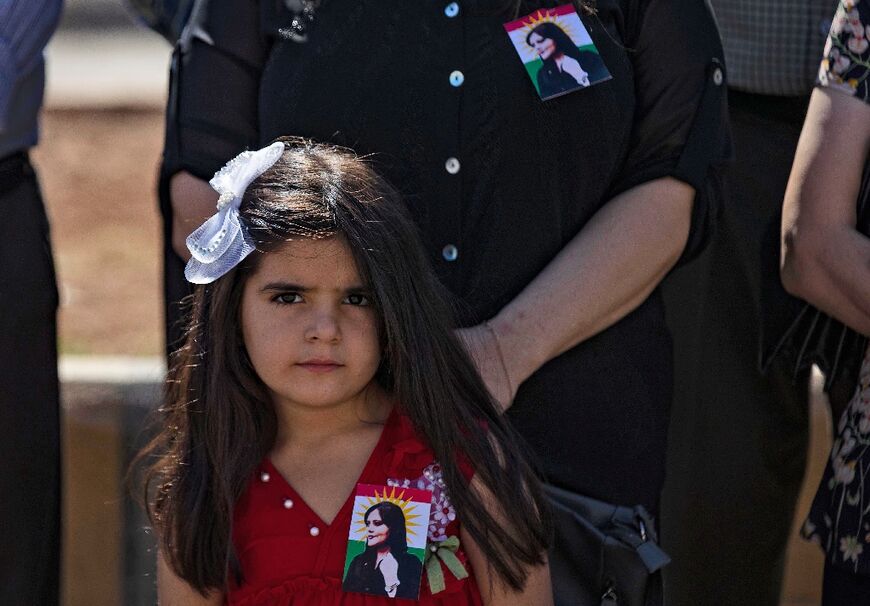 A young girl at a protest over the death of Mahsa Amini, in Qamishli in Syria's northeast 