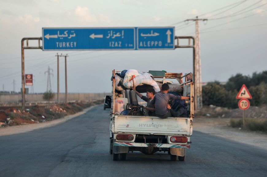 Civilians flee with their belongings as the Hayat Tahrir al-Sham alliance (HTS), led by Al-Qaeda's former Syria affiliate, advances on the key town of Azaz