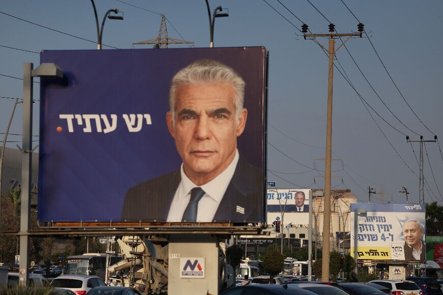 Caretaker premier Yair Lapid of the Yesh Atid party seen on a Tel Aviv campaign banner